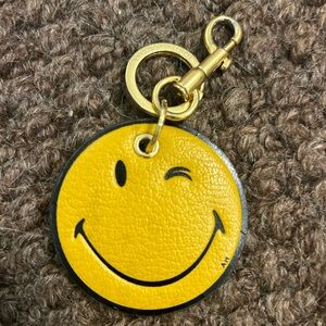 Anya Hindmarch smiley face charm.